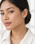 Model wearing the Frost Asia round moissanite stud earring in a white-metal finish